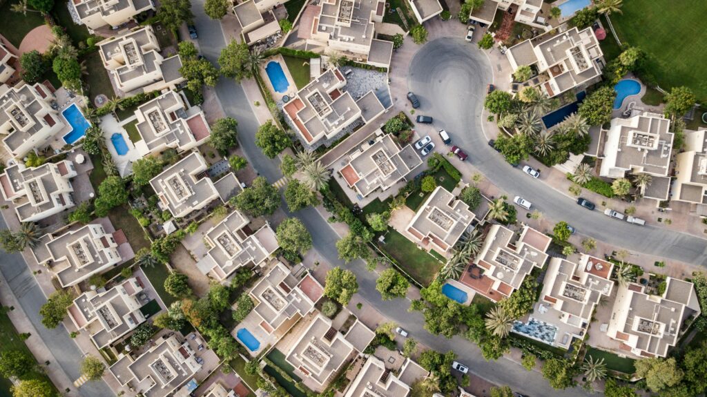 pexels-photo-1642125-1642125 Explore a stunning aerial view of a residential area in Dubai with lush greenery and swimming pools.